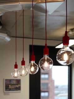 several light bulbs hanging from the ceiling in an office