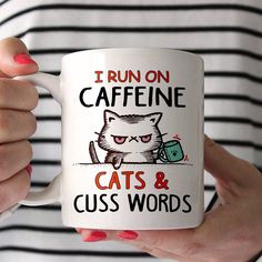 a woman is holding a coffee mug that says i run on caffeine cats and cuss words