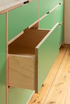 a green cabinet with two drawers in it