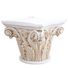 a white vase with an ornate design on the top and bottom, sitting in front of a white background