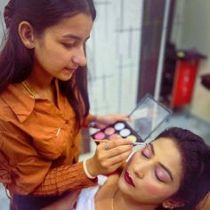 a woman getting her make up done in a beauty salon