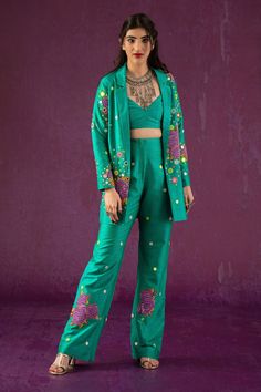 Green lapel collared blazer, elevated with rose pattern and thread embroidery. Comes with flared hem pant and bustier.
Components:3
Pattern:Embroidery
Type of Work:Floral,Mirror
Neckline:Lapel Collar
Sleeve Type:Full Sleeves
Fabric:Dupion Art Silk
Color:Green
Other Details:
V neck bustier
Occasion:Party,Resort - Aza Fashions Green Cotton Pants, Function Dresses, Floral Mirror, Pink Suit, Simple Pakistani Dresses, Embroidery Floral, Pattern Embroidery, How To Hem Pants, Indian Fashion Designers