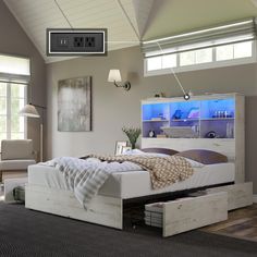 a white bed sitting in a bedroom next to a dresser and window with an aquarium on the wall