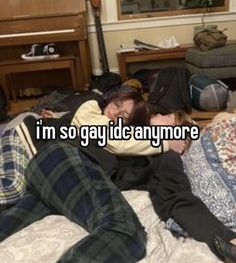 two people laying on a bed with the caption i'm so gay id anyone