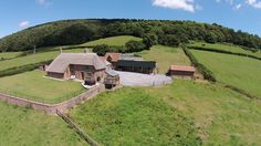 an aerial view of a farm house in the countryside