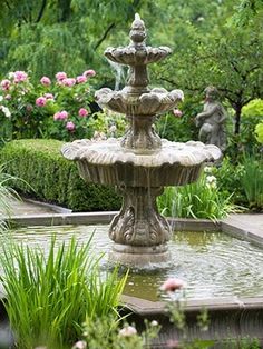 a water fountain in the middle of a garden