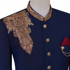 a man's blue jacket with gold and red details on the collar, sleeves and chest