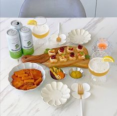 a table topped with plates and bowls filled with food