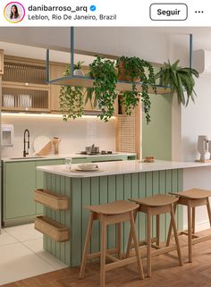 an image of a kitchen setting with plants on the counter and stools in front