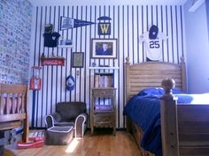 a bedroom with striped walls and wooden floors