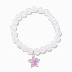 Give your day a glittery star with this stretch bracelet. It has white beads and a purple glittery star charm that glows in the dark. For best results, expose the glow-in-the-dark charm to light. Fit: Stretch Material: Plastic - Claire's Purple Star Glow in the Dark White Stretch Beaded Bracelet Light Purple Bracelet, Pink Glow Bracelets, Silver Glow In The Dark Jewelry For Party, Purple Star-shaped Bracelets For Gifts, Purple Star Necklace, White Beads, Star Charms, Stretch Bracelets, Glow In The Dark