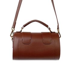 Our Mini Coffee Barrel Hand Bag is a small cross-body piece that is truly understated! Its carries a dated vintage tone that takes you on a journey that can be translated to both season-less and glamorous. 100% Genuine Leather Double rotary fasteners Open internal compartment with single rear wall pocket Adjustable and Removable shoulder strap Bright gold hardware 8" (L) x 4"(W) x 6"(H) Small Crosses, Bright Gold, Wall Pockets, Gold Hardware, Barrel, Shoulder Strap, Top Handle Bag, Genuine Leather, Handbags