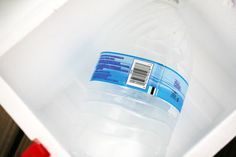 a bottle of water sitting inside of a white box