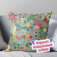 a colorful pillow with the words support independent artists in pink and blue colors on it