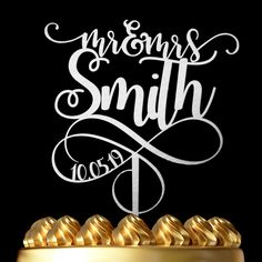 a cake with gold icing that says, mr and mrs smith on the top