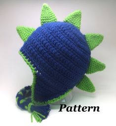 a crocheted blue and green hat with spikes on it's brim