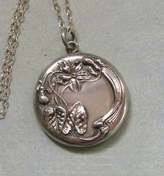 Antique Art Nouveau Locket Necklace With Floral Motif, Antique Nouveau Locket Necklace, Gift for Her A beautiful and feminine Art Nouveau locket with a gorgeous floral design.  The locket is circa the early 1900's and is sterling silver.  The floral design is done in high relief and has the sinuous lines of the Art Nouveau period.  The locket has a beautiful monogram of "EB" on the back.  I have kept the original black and white pictures of the adorable kids inside.  The locket is suspended from Antique Silver Engraved Necklaces For Wedding, Elegant Hallmarked Locket Necklace For Wedding, Artistic Hallmarked Jewelry For Formal Occasions, Polished Medallion Jewelry For Wedding, Silver Locket Jewelry For Formal Occasions, Wedding Jewelry With Polished Medallion Finish, Ornate Locket Jewelry For Wedding, Ornate Wedding Locket Jewelry, Artistic Engraved Formal Jewelry