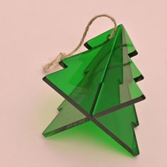 a green christmas tree ornament hanging from a string