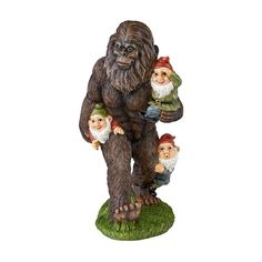 a statue of an orangua with two gnomes