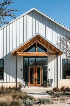 Sleek barndominium interior with exposed beams, white walls, and farmhouse-inspired decor