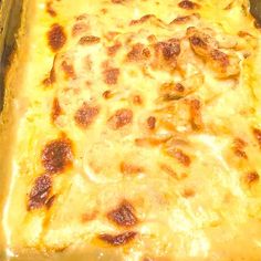 a casserole dish with cheese and meat in it