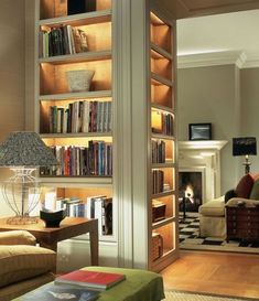 a living room filled with furniture and bookshelves