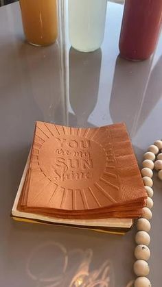 a book on a table with beads around it