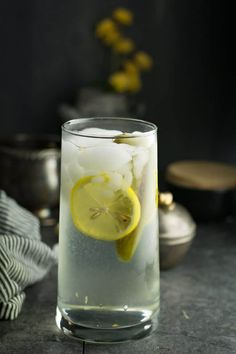 a glass filled with ice and lemon slices