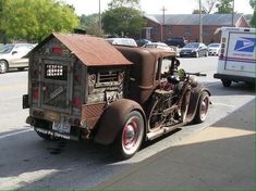 an old truck is parked on the side of the road