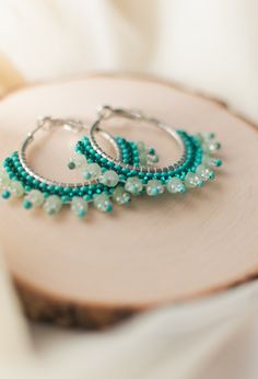 This is a handmade seed bead hoop earring. Used with high quality materials, on a high quality zinc alloy hoop. This item contains Dyed Aventurine gemstone beads. Aventurine is often associated with being the "Stone of opportunity. It is known to be the stone of perseverance. A great accessory at add to any outfit whether it is a casual day or a fancy outing. It is also August'd birthstone. Size: (40) mm Pleased be advised that these earrings are of high quality however it is advised that all it Gift Dangle Hoop Earrings With Spacer Beads, Hoop Earrings With Spacer Beads As Gift, Hoop Earrings With Spacer Beads For Gifts, Bohemian Green Hoop Earrings Hypoallergenic, Green Bohemian Hoop Earrings Hypoallergenic, Round Hoop Earrings With Spacer Beads For Gift, Bohemian Green Hypoallergenic Hoop Earrings, Nickel-free Metal Hoop Beaded Earrings, Spacer Beads Small Hoop Jewelry For Gift