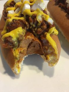 a hot dog with cheese and other toppings on it