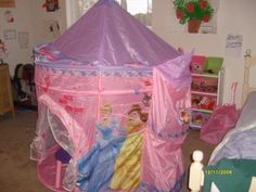 a pink princess castle bed in a child's bedroom