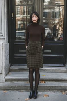 Office chic meets winter warmth. This olive houndstooth pencil skirt paired with a dark brown turtleneck and black tights is the perfect blend of style and comfort. Perfect for those chilly office days. Winter Skirt Tights Outfit, Houndstooth Pants Outfit Winter, Plaid Midi Skirt Outfit Winter, Autumn Outfits With Tights, Light Academia Outfit Skirt, Brown Skirt Black Tights, Brown Houndstooth Skirt Outfit, Midi Skirt With Tights, Gray Pencil Skirt Outfit