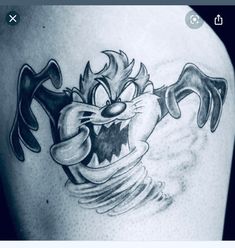 a cartoon character tattoo on the back of a man's shoulder