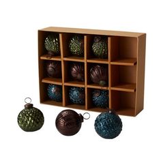 several ornaments are arranged in a cubby for display on a white background with clippings