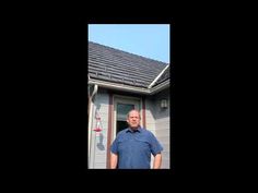 a man standing in front of a house