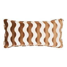 a brown and white pillow with wavy lines on the front, sitting on a white background