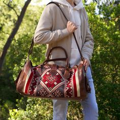 Handcrafted Vegetable-Tanned Brown Leather and Kilim Duffel Bag: Tradition & Adventure Discover a travel companion beyond the ordinary. Our handcrafted duffel bag merges the rich heritage of vegetable-tanned top-grain leather with the vibrant artistry of unique kilim designs. Each kilim panel is a captivating story woven by skilled artisans. This fusion elevates your style and complements your adventurous spirit. Unveiling the Legacy of Your Duffel: Sustainable Luxury: Crafted from 100% vegetabl Brown Weekender Bag With Top Carry Handle, Rectangular Vegetable-tanned Satchel For Travel, Brown Vegetable-tanned Satchel For Travel, Brown Weekender Bag For Overnight Trips, Artisan Travel Shoulder Bag With Leather Lining, Artisan Shoulder Bag With Leather Lining For Travel, Artisan Shoulder Bag For Travel With Leather Lining, Brown Duffle Bag With Top Handle For Weekend Trips, Brown Weekender Bag With Top Carry Handle For Trips