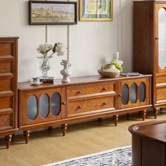 a living room scene with focus on the entertainment center and sideboard in the foreground