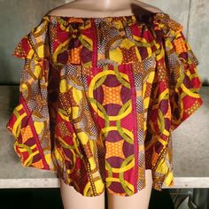 Beautiful Ankara Ruffle Top Free Size Up To 2xl Beautiful Bright Color Authentic African Wax Cotton Will Fit Up To A Size 2xl Comfortably New Can Be Worn Off Or On The Shoulders Great Coverage In The Bust And Stomach Area The Top Measures Bust 42 Inches Bottom Hem 43 Inches No Stretch Except For The Top Shoulder And Chest Area. Beautiful Blouse Over Ruffle Style At The Front And Back #Ankaratop #Blousetop #Africantop #Ruffletop #Abstracttop #Africanclothing Casual Yellow Tops With Colorful Pattern, Colorful Pattern Red Tops For Beach, Red Cotton Tops With Colorful Pattern, Yellow Vibrant Print Short Sleeve Tops, Cotton Tops With Vibrant Print, Red Colorful Pattern Blouse, Vibrant Yellow Short Sleeve Tops, African Attire Dresses, African Tops