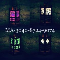 four different colored lanterns are lit up in the dark