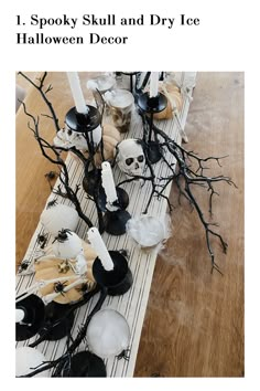 the table is decorated with black and white halloween decor, including candles, skulls, and other decorations