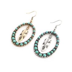 Navajo inspired faux turquoise stone hoop with dangling feather accent. Tiny flowers in between the top stones add a delightful detail. Metal Type: Zinc Alloy Length: 1.8" (4.6cm) Coast Cowgirl, Boho Drop Earrings, Boho Chic Earrings, Dangle Earrings Boho, Hippie Earrings, Chic Earrings, Silver Feather, Ethnic Earrings, Cross Earrings