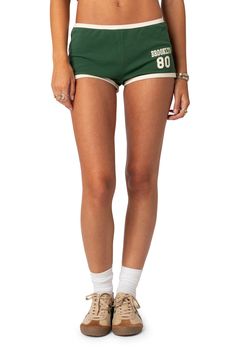 Rep your favorite city in these vibrant cotton knit shorts designed in a leggy silhouette with contrasting trim. 95% cotton, 5% spandex Machine wash, dry flat Imported Green Shorts Outfit, Streetwear Shorts, Contrasting Trim, Black Graphic Tees, Swimwear Dress, Designer Shorts, Back To School Outfits, Green Shorts, Knit Shorts