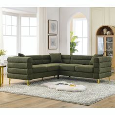 a green sectional sofa sitting on top of a rug