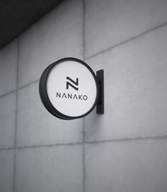 a black and white sign on the side of a building that says nannako