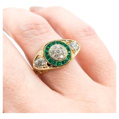 Antique Old European Diamond & Emeralds Target Ring in 14K Gold Experience timeless elegance with this beautiful antique target ring, intricately crafted in 14k Yellow Gold with filigree details. This exquisite piece is adorned with .80ctw Old European Diamonds that dazzle with an SI clarity and a near-colorless hue. Complementing these sparkling diamonds are .42ctw vibrant Emeralds, infusing the ring with a splash of lush green. The ring is currently sized at a 5.5. Weighing a comfortable 3.7 grams, this ring is a perfect blend of history, art, and luxury. This stunning antique ring would make an excellent addition to any fine jewelry collection. Emerald's soothing energies strengthen relationships and open the heart chakra, allowing for deeper connections with oneself and others. Emerald Target Ring, Gold Experience, Art Deco Emerald, History Art, Antique Ring, Ring Art Deco, Fine Jewelry Collection, Lush Green, Sparkle Diamonds