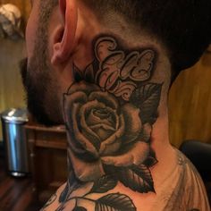 a man with a neck tattoo that has a rose on it and the word love written in cursive letters