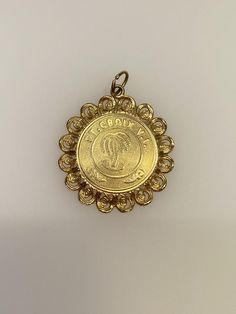 Vintage 14k yellow gold St. Croix charm. The charm weighs 3 grams of gold. 14k Gold Coin Jewelry Stamped 14k, Engraved 14k Gold Medallion Charms, Vintage 22k Gold Engraved Jewelry, Engraved Yellow Gold Medallion Charms, 14k Gold Engraved Medallion Charms, 14k Gold Medallion Engraved Charms, Vintage Yellow Gold-plated Charm, Vintage Yellow Gold Plated Charm, Antique 14k Gold Necklace With Charms