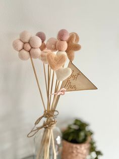 a vase filled with pink and white pom - poms on top of a table